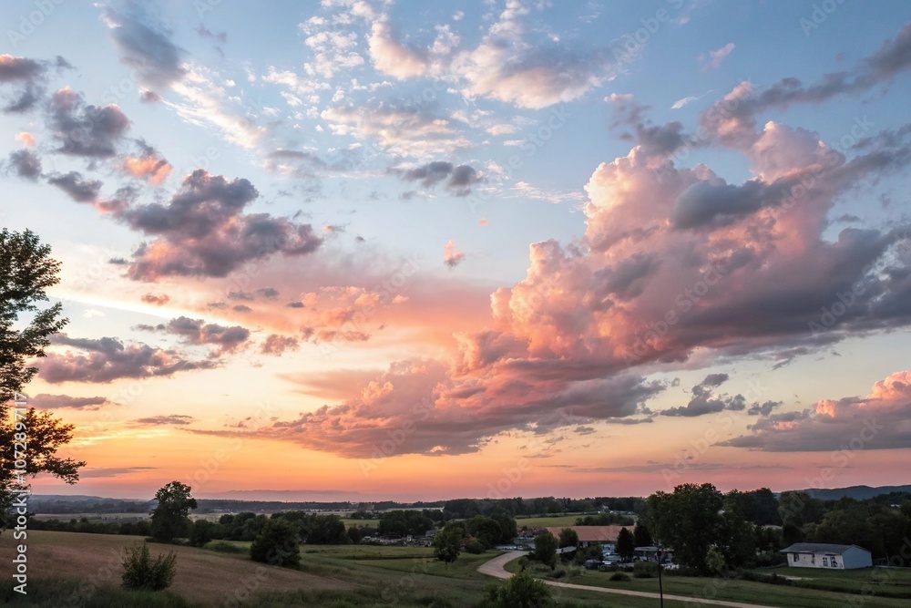 Fototapeta premium Soft pastel clouds drift lazily across the sky at sunset, tranquil mood, gentle hues, beautiful sunset