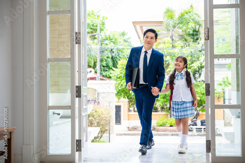 Back to school. Family Asian father and daughter entering main door of home, Father and daughter walked back into the house. After the child leaves school And father has already left work