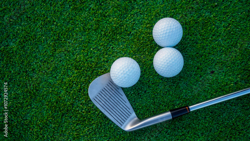 Close up of golf equipment on green grass.