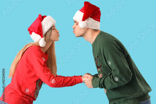 Young couple in Santa hats ...