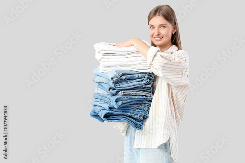 Young woman with stack of c...
