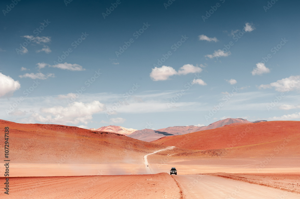 Altiplano plateau, Bolivia. Off-road cars driving on the road in the desert.
