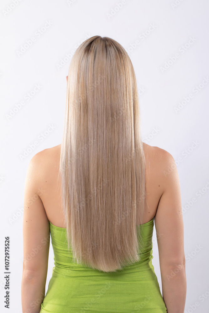 An elegant woman showcasing her long flowing hair while wearing a beautiful green dress An elegant woman showcasing her long flowing hair while wearing a beautiful green dress