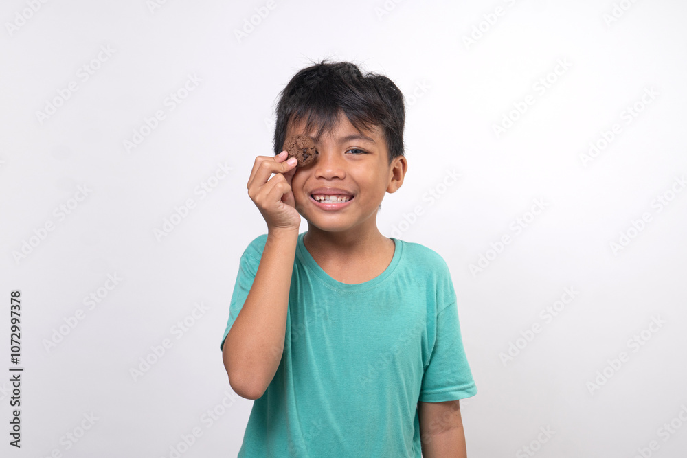 young boy hanging tasty cookies on white background young boy hanging tasty cookies on white background
