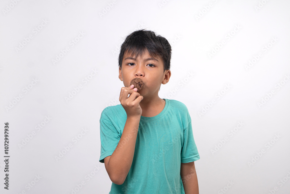 young boy hanging tasty cookies on white background young boy hanging tasty cookies on white background