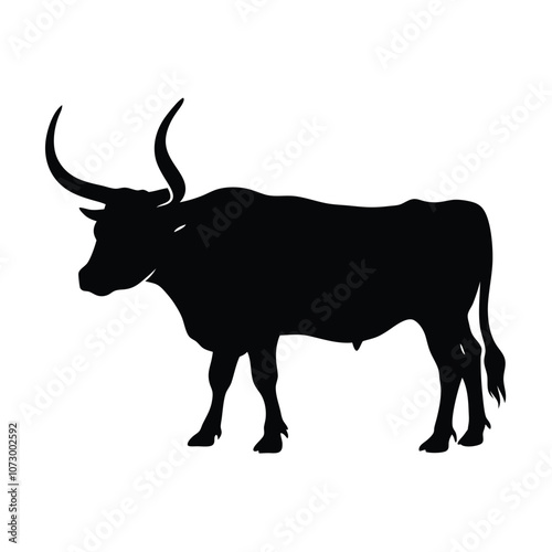 a angry bull. The bull is standing on all fours and is facing towards silhouette
