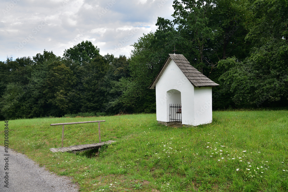 A white clay chapel for prayer connected to a hoe with a meadow traditionally