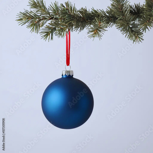 Matte blue ball Christmas ornament in a white background.