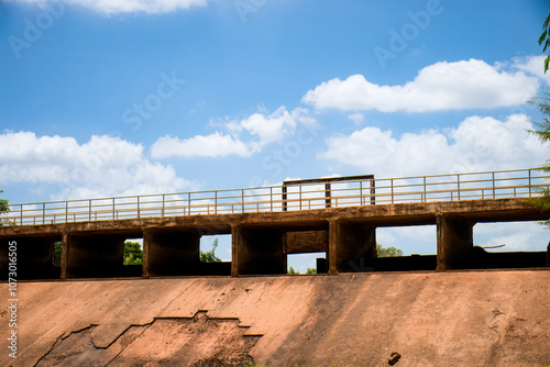 Concrete Bridge Over Waterway With Blue Sky and Clouds.