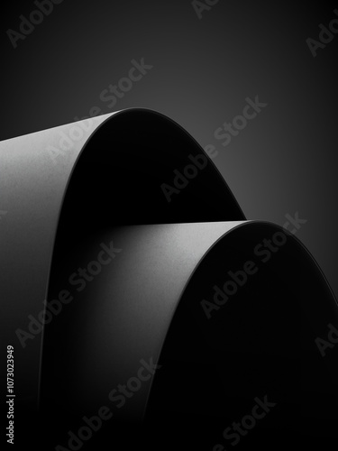 Curved black surfaces with soft lighting, creating a minimalist and abstract look. Light and shadow highlight the smooth texture, adding elegance and depth.