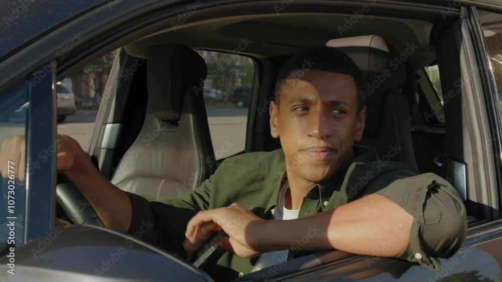 Successful thoughtful African American male entrepreneur sitting in drivers seat, looking with pensive expression , pondering about business matters during road trip. Successful thoughtful African American male entrepreneur sitting in drivers seat, looking with pensive expression , pondering about business matters during road trip.