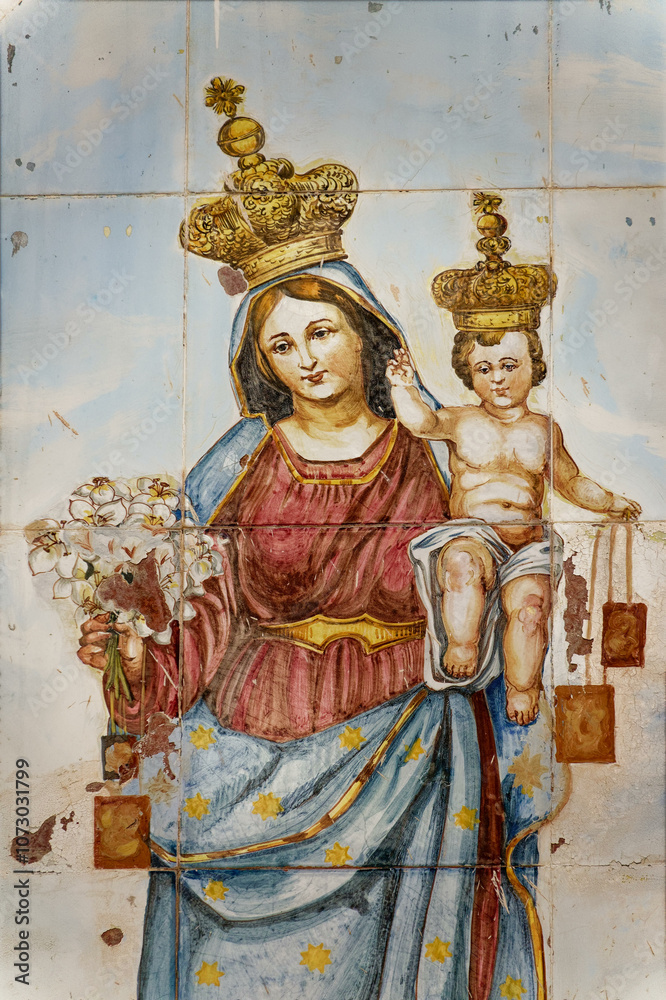 Fototapeta premium Mural painting on tiles of Blessed Virgin Mary holding baby Jesus Christ in her arms. ..