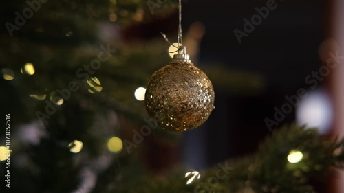 a beautiful ball on a jewelry tree, close-up, lights are burning in the background