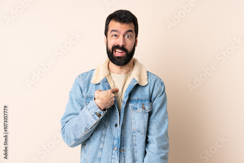 Caucasian man with beard over isolated background pointing to oneself