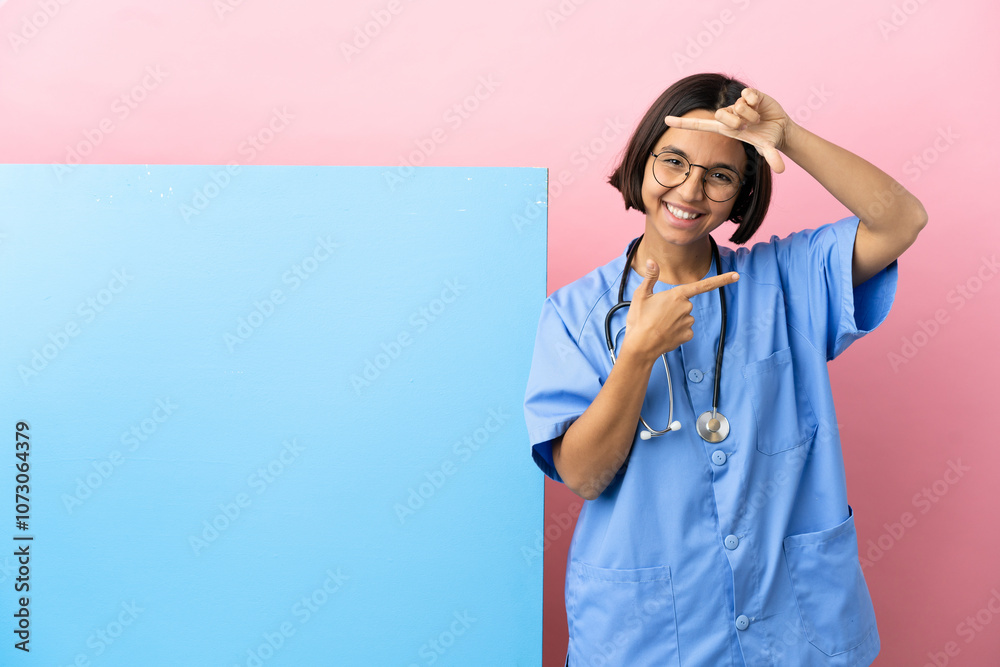 Young mixed race surgeon woman with a big banner over isolated background focusing face. Framing symbol Young mixed race surgeon woman with a big banner over isolated background focusing face. Framing symbol