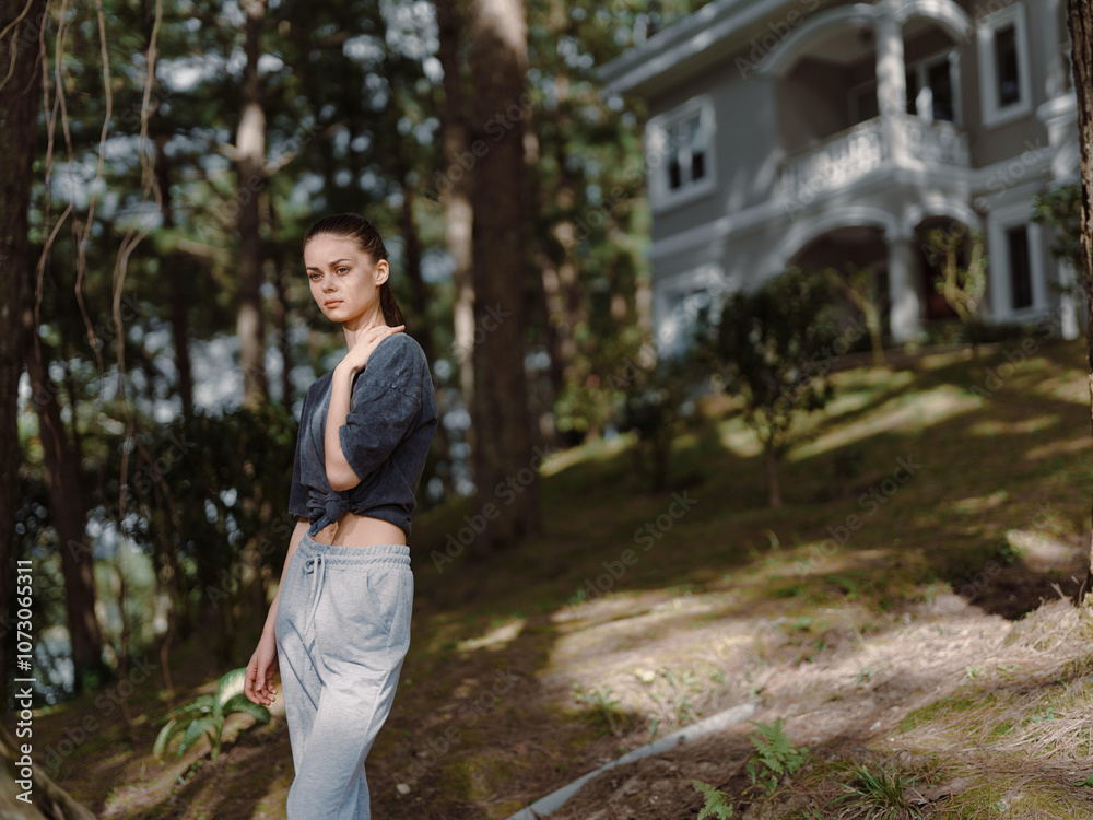 Thoughtful young woman standing in a peaceful garden, wearing casual clothing, surrounded by greenery and a serene house in the background Nature and tranquility concept Thoughtful young woman standing in a peaceful garden, wearing casual clothing, surrounded by greenery and a serene house in the background Nature and tranquility concept