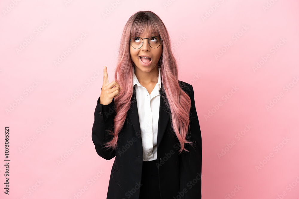 Young business mixed race woman with pink hair isolated on pink background pointing up and surprised Young business mixed race woman with pink hair isolated on pink background pointing up and surprised