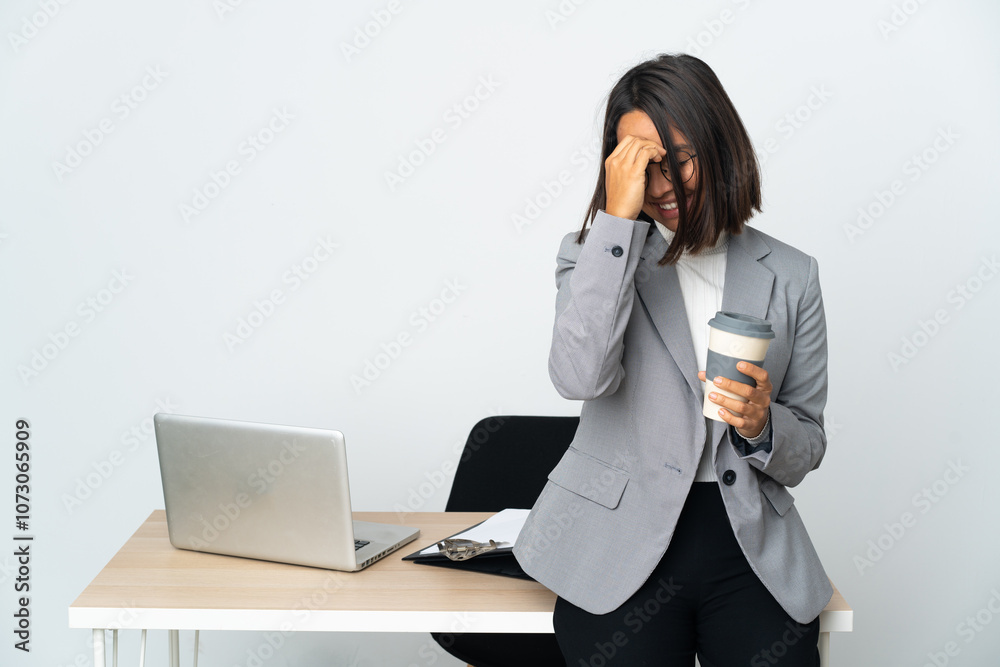 Young latin business woman working in a office isolated on white background laughing Young latin business woman working in a office isolated on white background laughing