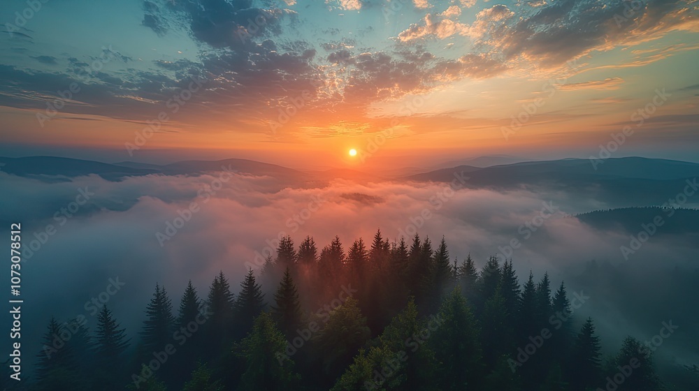 A breathtaking aerial view of a sunrise over a mountain range, with fog and a forest silhouetted in the foreground. A breathtaking aerial view of a sunrise over a mountain range, with fog and a forest silhouetted in the foreground.