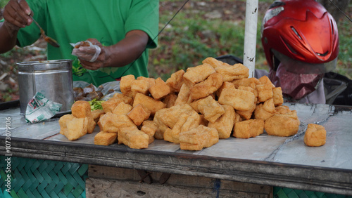 Fried tofu, tahu goreng and petis are sold on the side of the road. Street Food concept photo