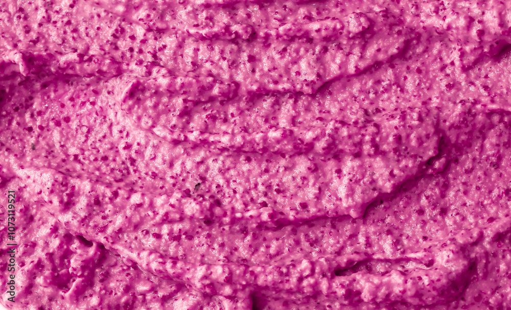 Obraz premium Purple berry yogurt ice cream. Fresh fruit and berry smoothie currant, pitaya, fig, grape, plum. Ice cream texture. Delicious sweet dessert close-up as background.