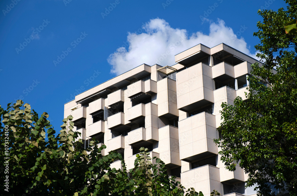 Building with square pattern standing tall in the sky Building with square pattern standing tall in the sky