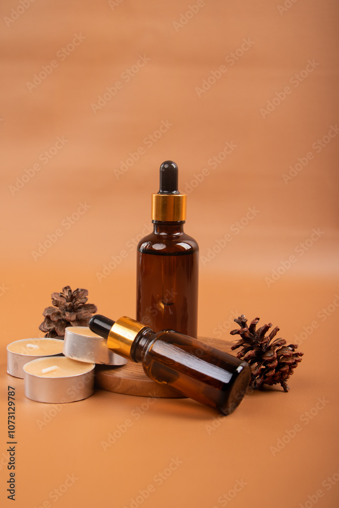 Amber Dropper Bottles with Tealight Candles on Warm Background for Spa and Aromatherapy Amber Dropper Bottles with Tealight Candles on Warm Background for Spa and Aromatherapy