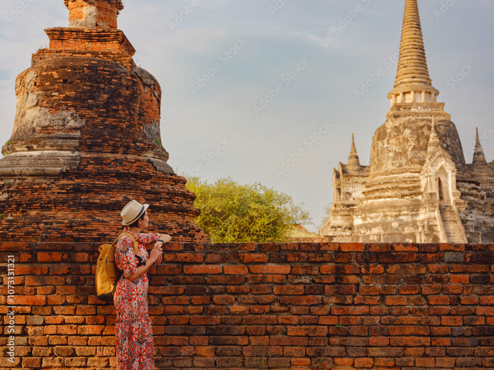 Φωτογραφία Young female tourist in dress exploring historic park of Ayutthaya, Thailand