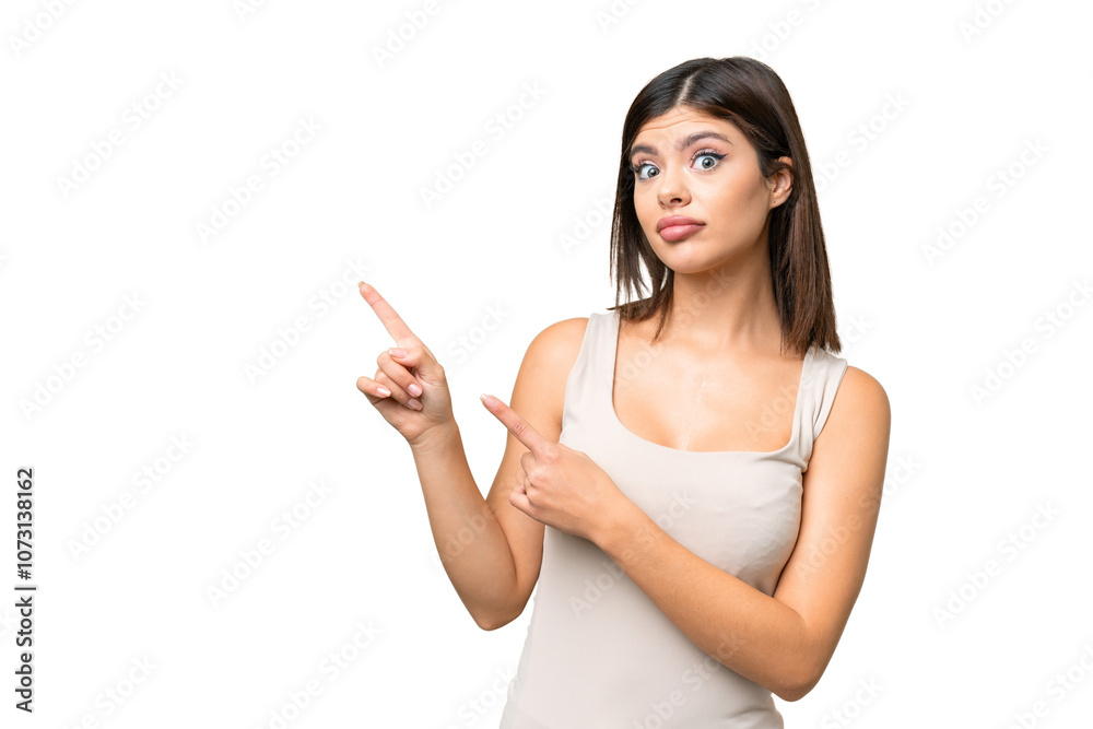 Young Russian woman over isolated chroma key background frightened and pointing to the side Young Russian woman over isolated chroma key background frightened and pointing to the side