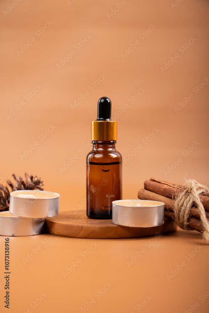 Amber Dropper Bottle with Cinnamon Sticks and Tealight Candles on Wooden Tray for Aromatherapy and Skincare Amber Dropper Bottle with Cinnamon Sticks and Tealight Candles on Wooden Tray for Aromatherapy and Skincare