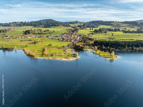 aerial landscape photo of with Lake Rottachspeicher between pastures and colorful autumn forests in the upper Allgaeu in Petersthal, next to Kempten Kempten