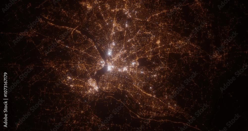 Louisville (Kentucky, USA) aerial view at night. Top view on modern city with street lights. Camera is zooming out, rotating clockwise. Vertical video. The north is on the left side
