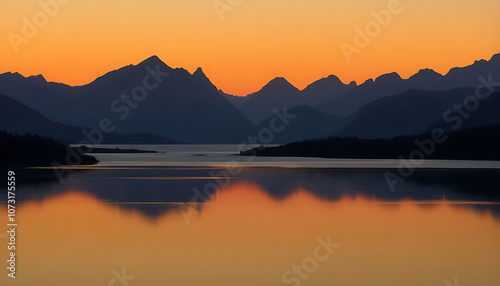 Sunset in the mountains at a calm lake - Sunset over the mountain reflection at golden hour, Calm mountain lake reflecting the sunset in the mountains, dawn