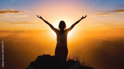 Silhouette of a Woman Celebrating Success, Freedom on a Mountain Summit at Golden Sunrise