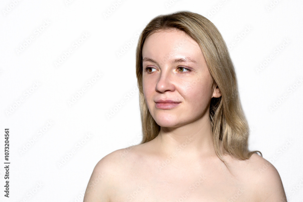 Portrait of a fair girl with heterochromia and bare shoulders on a white background. Portrait of a fair girl with heterochromia and bare shoulders on a white background.