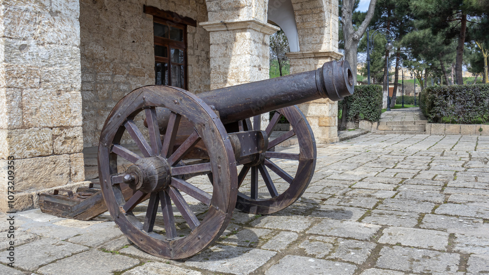 A fortress cast-iron cannon in an ancient fortress. Ancient weapons that fired cast-iron balls. Smooth bore cast iron cannon mounted on a wooden carriage. A fortress cast-iron cannon in an ancient fortress. Ancient weapons that fired cast-iron balls. Smooth bore cast iron cannon mounted on a wooden carriage.