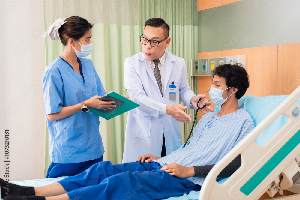Asian doctor, nurse, and happy male patient in hospital bed showing thumbs up, indicating positive recovery and satisfaction services. Medical professionals, hospital teamwork, and medical healthcare Asian doctor, nurse, and happy male patient in hospital bed showing thumbs up, indicating positive recovery and satisfaction services. Medical professionals, hospital teamwork, and medical healthcare