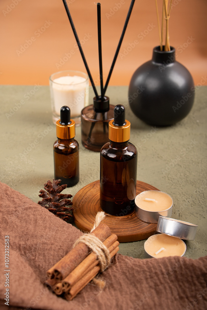 Amber Dropper Bottles with Candle and Reed Diffuser for Aromatherapy and Skincare Mockup on Green Background Amber Dropper Bottles with Candle and Reed Diffuser for Aromatherapy and Skincare Mockup on Green Background