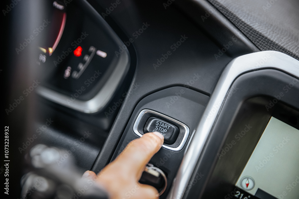 Start stop engine button, car driver starting the car