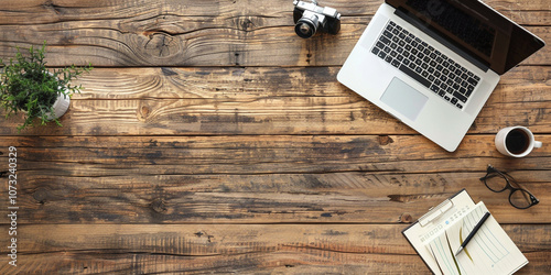 Professional Workspace with Camera and Laptop on Wooden Desk
