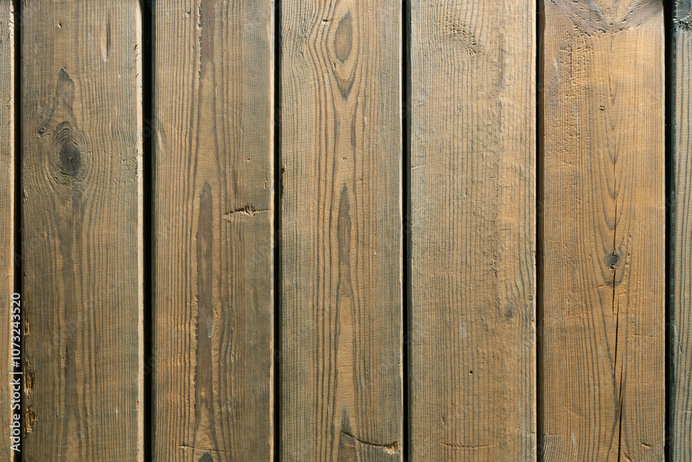 The old wooden plank is weathered, cracked, and rough.