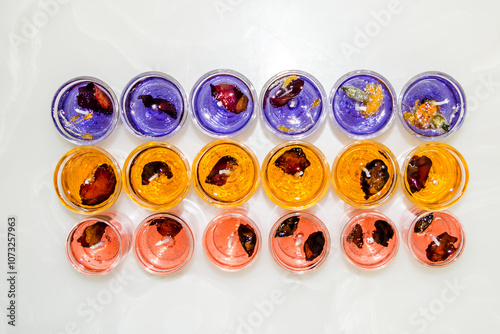 Gel candle in glass isolated on white background. set of colored gel candles. Candle in glass with many colored candles.