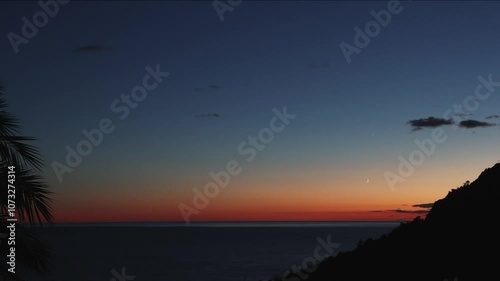 Silhouette Sunset and half moon landscape in italy