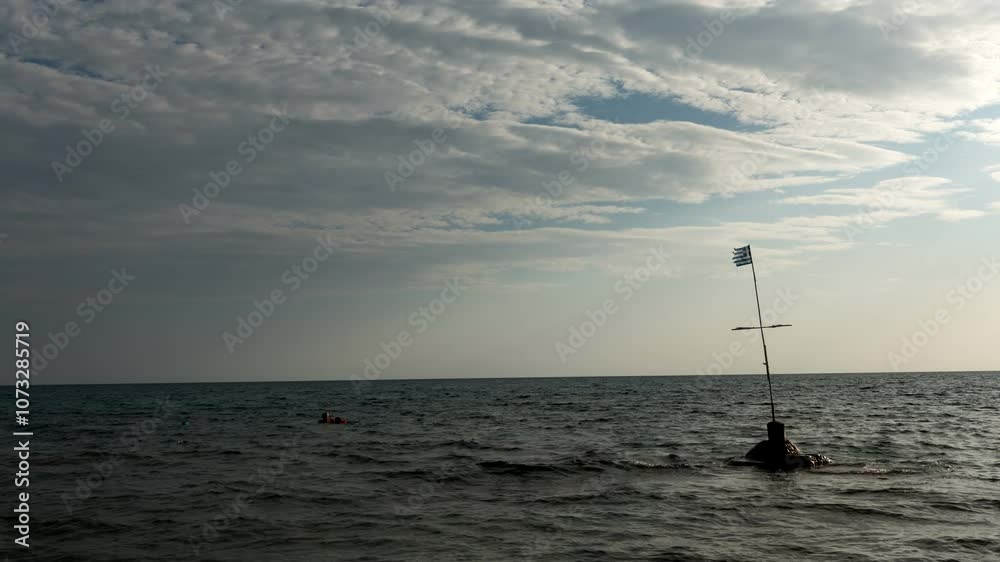 Time lapse panorama of sea scene with gentle waves lapping the shore, a distant tranquil sky filled with soft clouds and two small boats anchored in the still water view. Time lapse panorama of sea scene with gentle waves lapping the shore, a distant tranquil sky filled with soft clouds and two small boats anchored in the still water view.
