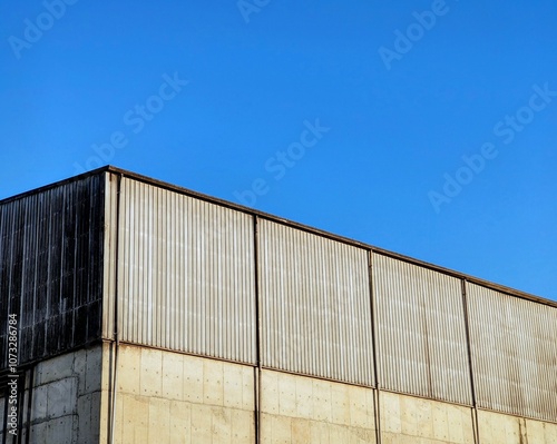 Wallpaper Mural Aluminum corrugated industrial warehouse metal wall surface building on against blue sky background Torontodigital.ca