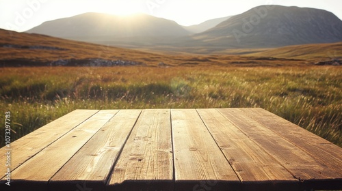 Empty wooden table on a grassy mountain plateau, morning sunlight casting shadows across the scenery