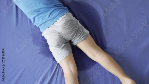 Above video of pee on a bed mattress,Bed Wetting sleep enuresis in Adults, baby or pet concept ,selected focus at wet on the bed sheet