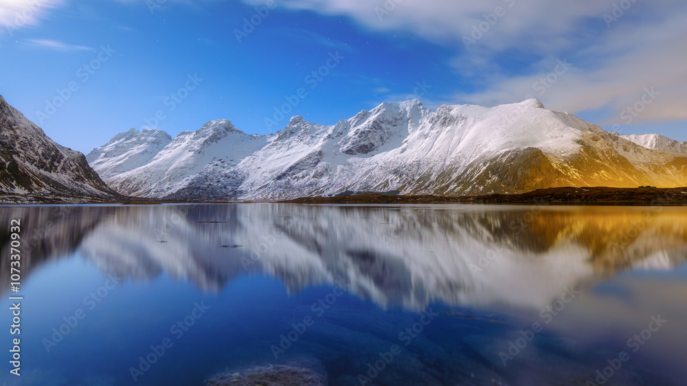 Lofoten islands, Norway. Panoramic landscape during moon light. Long exposure photography. Reflection on the water surface. Photo for background, wallpaper, postcards. Lofoten islands, Norway. Panoramic landscape during moon light. Long exposure photography. Reflection on the water surface. Photo for background, wallpaper, postcards.