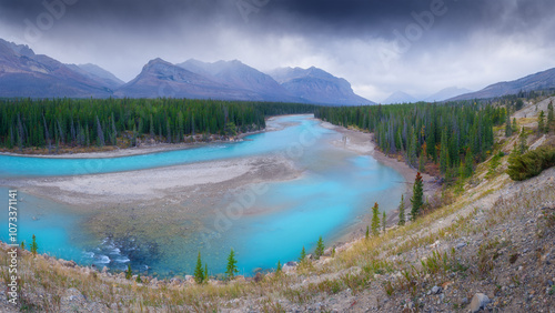 View of the river in the mountains valley. An aerial view of an forest. Winding river among the trees. Turquoise mountain water. Landscape with soft light before sunset. photo