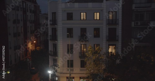 Timelapse of an urban residential building capturing the transition from day to night. This video illustrates the daily energy consumption and the impact of urbanization on the environment.
